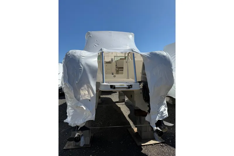 Slide: The Image of 2019 World Cat Glacier Bay Edition 2740 Dual Console boat, partially covered, on a sunny day. - 25