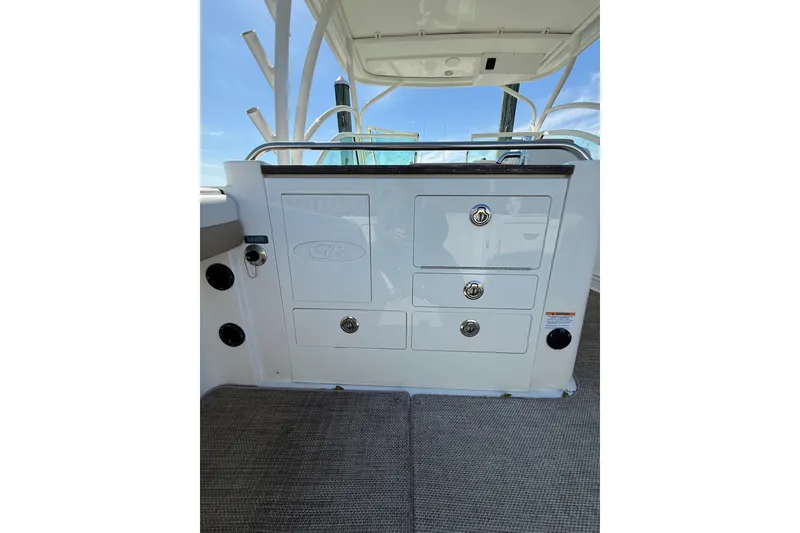 Slide: The Image of 2019 World Cat Glacier Bay Edition 2740 Dual Console interior with storage compartments. - 26