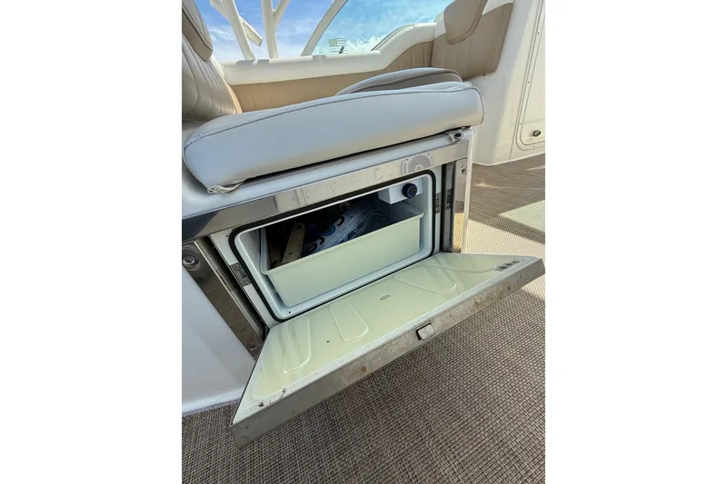 Slide: The Image of Open storage compartment on 2019 World Cat Glacier Bay Edition 2740 Dual Console boat. - 31
