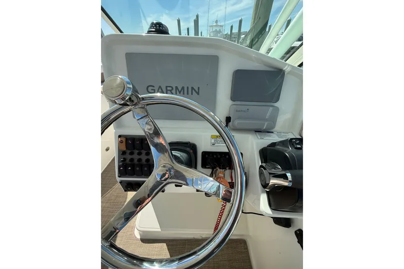 Slide: The Image of Steering wheel and controls of 2019 World Cat Glacier Bay Edition 2740 Dual Console boat. - 35