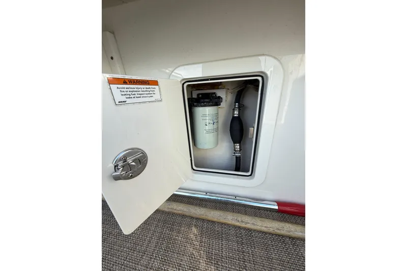Slide: The Image of 2019 World Cat Glacier Bay Edition 2740 Dual Console fuel system compartment with warning label. - 43