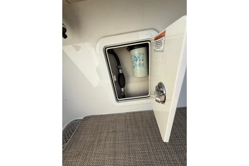 Slide: The Image of Open storage compartment on 2019 World Cat Glacier Bay Edition 2740 Dual Console boat. - 44
