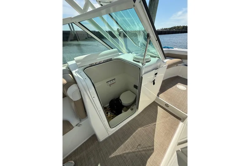 Slide: The Image of 2019 World Cat Glacier Bay Edition 2740 Dual Console boat interior with open storage compartment. - 45
