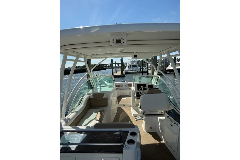 Slide: The Image of 2019 World Cat Glacier Bay Edition 2740 Dual Console boat interior, docked under clear blue sky. - 51