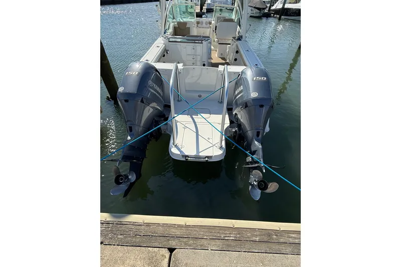 Slide: The Image of 2019 World Cat Glacier Bay Edition 2740 Dual Console with twin Yamaha 150 engines docked. - 59