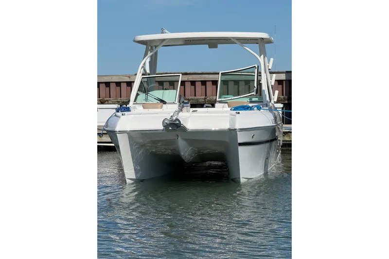 Slide: The Image of 2019 World Cat Glacier Bay Edition 2740 Dual Console boat docked in calm waters. - 62