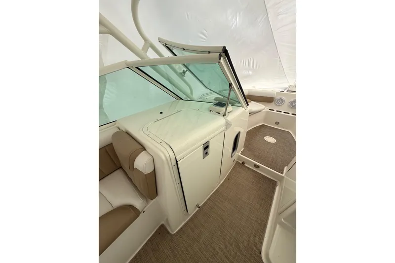 Slide: The Image of 2019 World Cat Glacier Bay Edition 2740 Dual Console interior with beige seating and carpet. - 7
