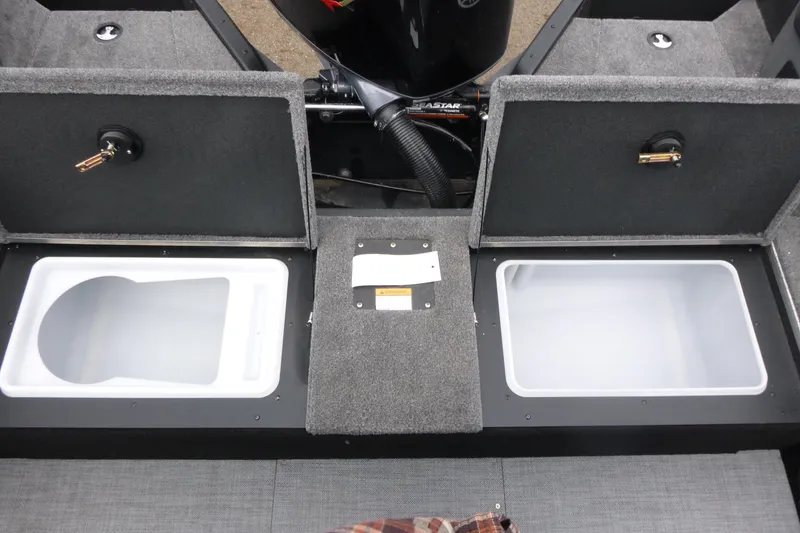 Slide: The Image of 2025 Alumacraft Trophy 185X Sport boat interior with storage compartments open. - 12
