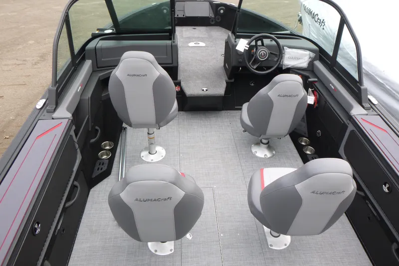 Slide: The Image of 2025 Alumacraft Trophy 185X Sport boat interior with four seats and steering console. - 4