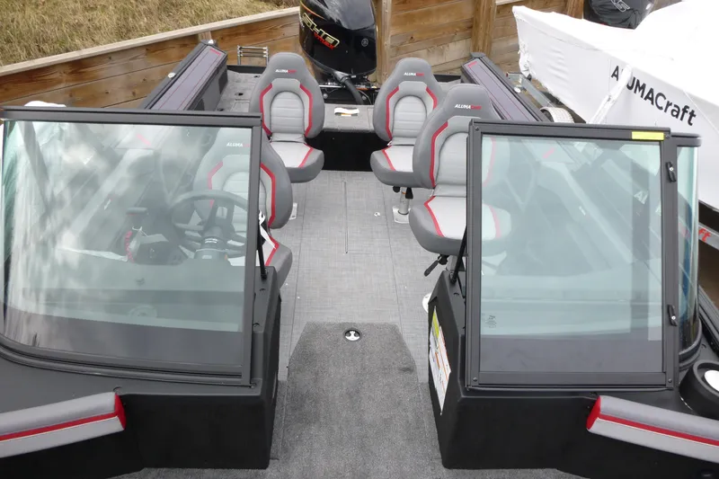Slide: The Image of 2025 Alumacraft Trophy 185X Sport boat interior with seating and steering wheel. - 5