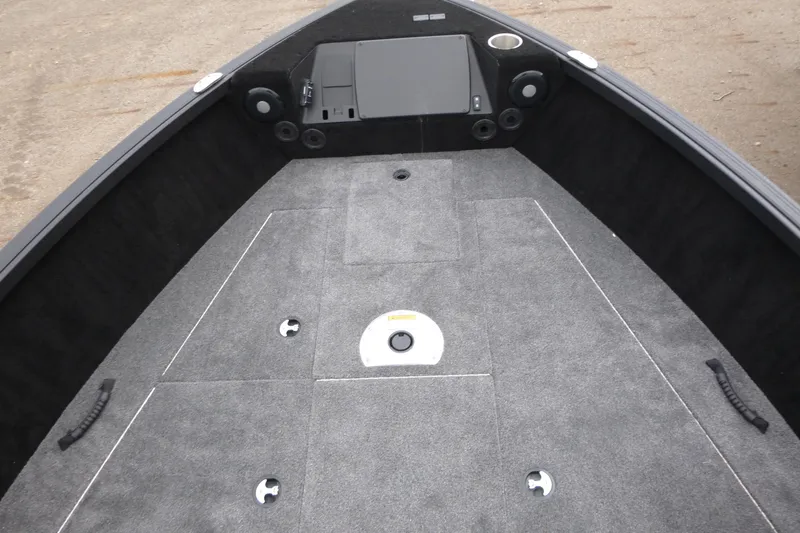 Slide: The Image of 2025 Alumacraft Trophy 185X Sport boat interior with carpeted deck and storage compartments. - 6