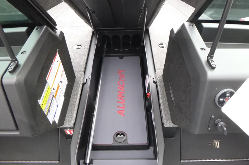 Slide: The Image of 2025 Alumacraft Trophy 185X Sport boat storage compartment with open hatch. - 7