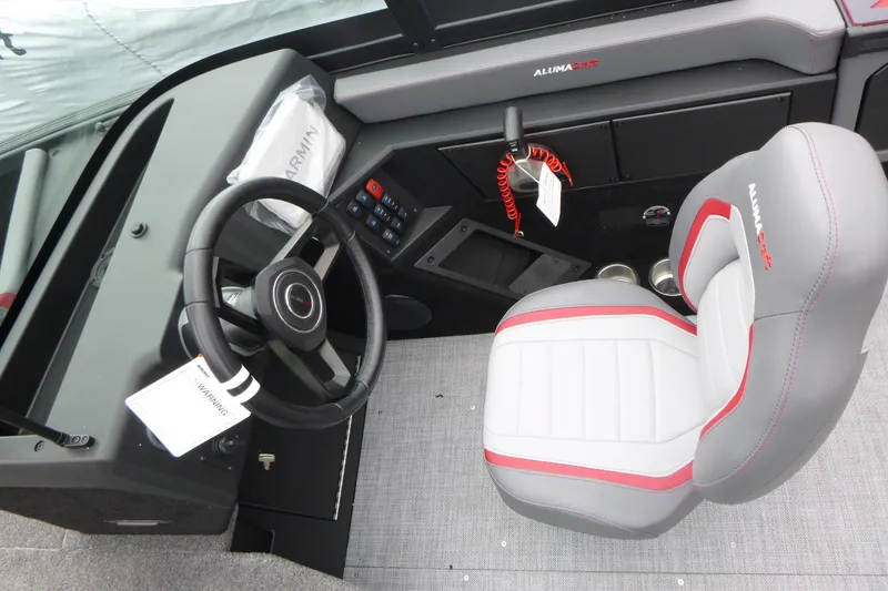 Slide: The Image of 2025 Alumacraft Trophy 185X Sport boat interior with steering wheel and captain's seat. - 8