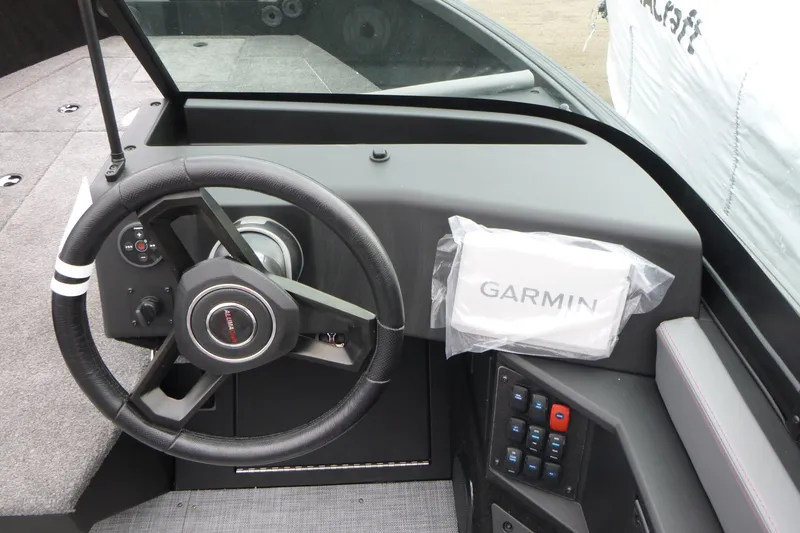 Slide: The Image of 2025 Alumacraft Trophy 185X Sport dashboard with Garmin navigation system and steering wheel. - 9