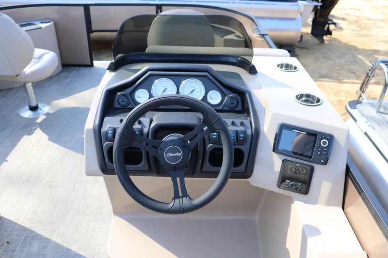 Slide: The Image of 2026 Bentley Pontoons Fish 220 4-Point dashboard with steering wheel and control panel. - 4