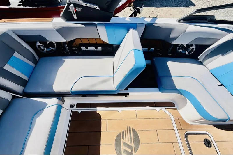 Slide: The Image of Interior seating of 2021 Malibu Wakesetter 23 MXZ with blue and gray upholstery. - 14