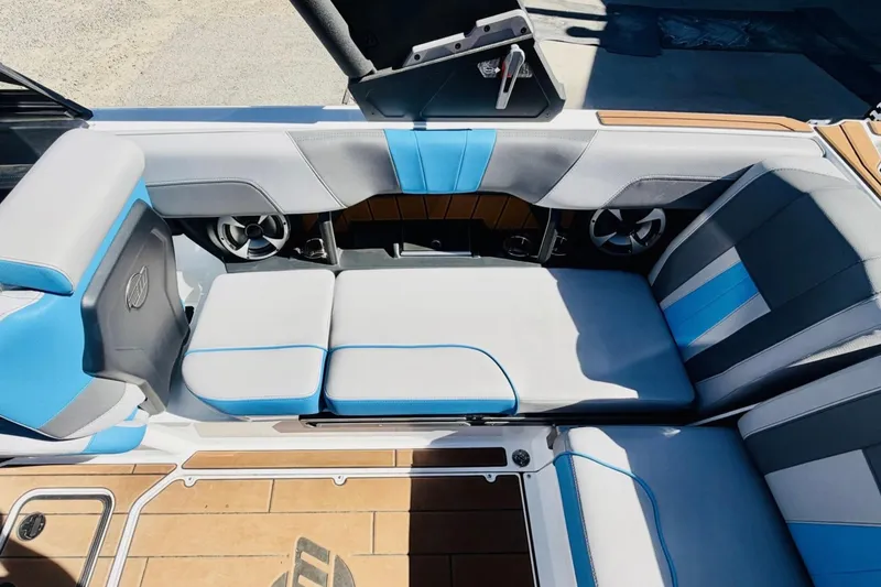 Slide: The Image of 2021 Malibu Wakesetter 23 MXZ interior with blue and gray seating. - 15