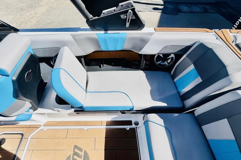 Slide: The Image of 2021 Malibu Wakesetter 23 MXZ interior with blue and gray seating. - 16