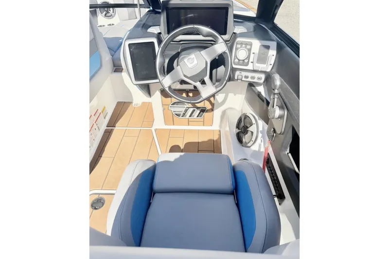 Slide: The Image of 2021 Malibu Wakesetter 23 MXZ boat cockpit with modern controls and steering wheel. - 17