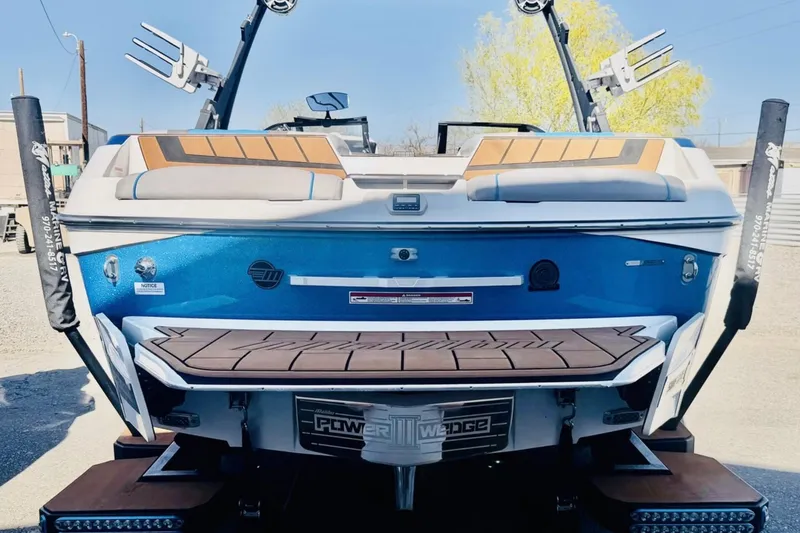 Slide: The Image of 2021 Malibu Wakesetter 23 MXZ boat, rear view, showcasing sleek design and Power Wedge feature. - 4