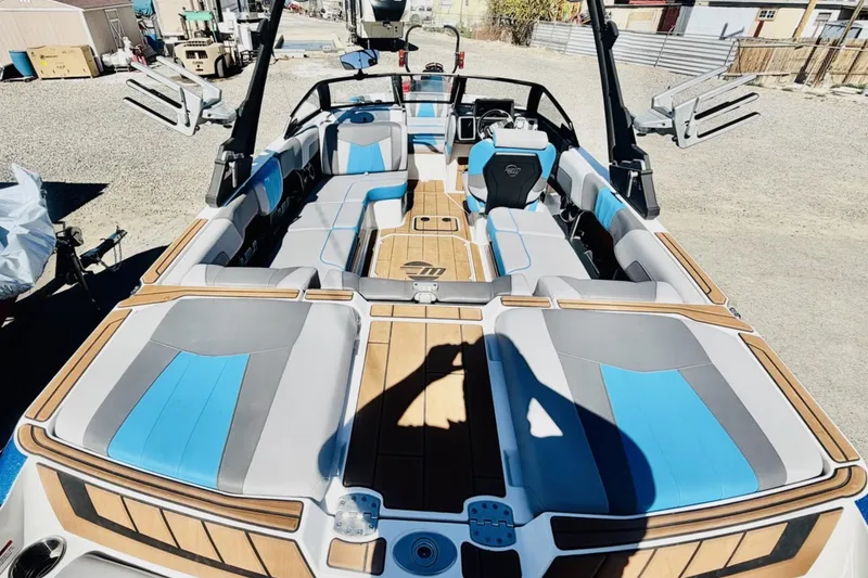 Slide: The Image of 2021 Malibu Wakesetter 23 MXZ boat interior with blue and gray seating. - 9