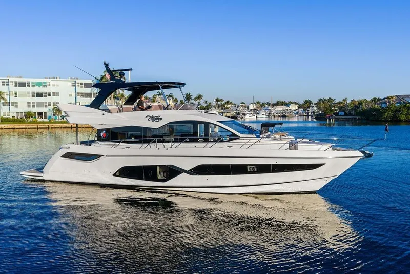 Slide: The Image of 2021 Sunseeker Manhattan 68 yacht on calm water, with modern design and luxurious features. - 13