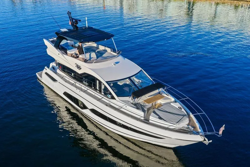 Slide: The Image of Luxurious 2021 Sunseeker Manhattan 68 yacht cruising on serene blue waters. - 15