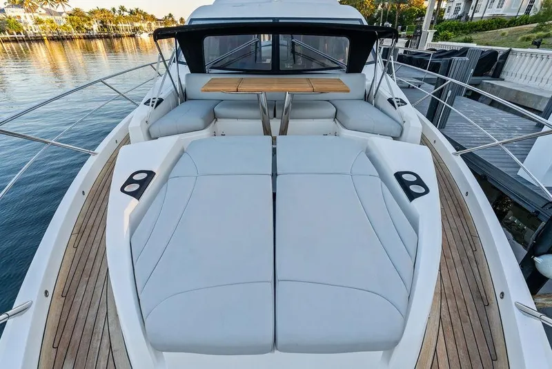Slide: The Image of Luxurious 2021 Sunseeker Manhattan 68 yacht deck with elegant seating and wooden flooring. - 18