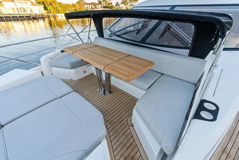 Slide: The Image of Luxurious Sunseeker Manhattan 68 yacht deck with elegant seating and wooden table, 2021 model. - 20