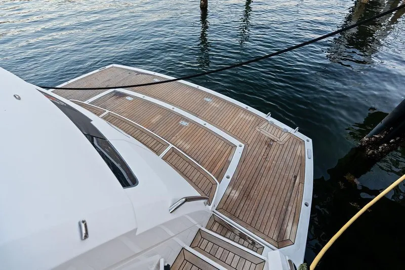 Slide: The Image of Sunseeker Manhattan 68 yacht's teak deck, 2021 model, docked by the water. - 22