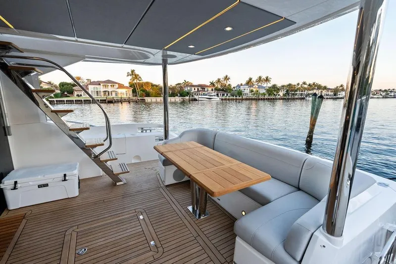 Slide: The Image of Luxurious Sunseeker Manhattan 68 yacht deck with seating, table, and waterfront view. - 24