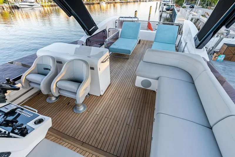 Slide: The Image of Luxurious 2021 Sunseeker Manhattan 68 yacht deck with seating and helm, docked by the water. - 30