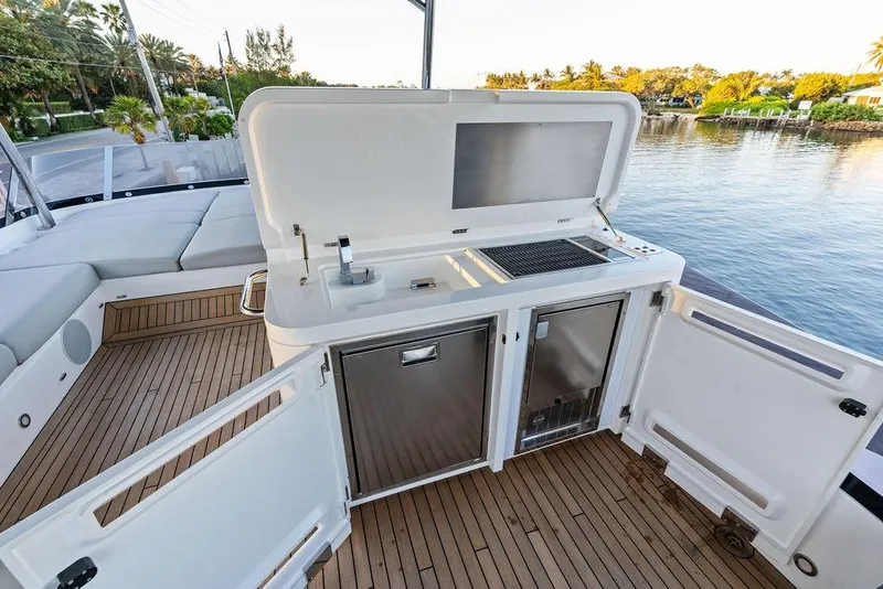 Slide: The Image of Luxurious 2021 Sunseeker Manhattan 68 yacht deck with outdoor kitchen and scenic water view. - 32