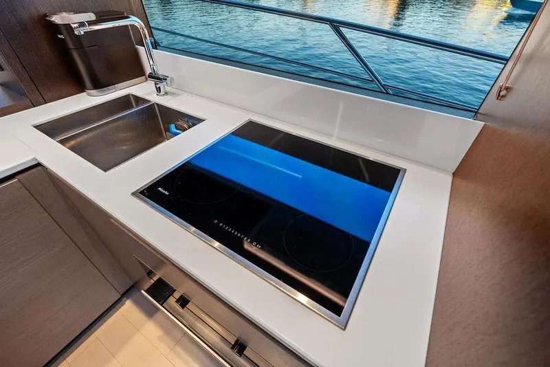 Slide: The Image of Modern kitchen area on 2021 Sunseeker Manhattan 68 yacht with sink and stovetop. - 43