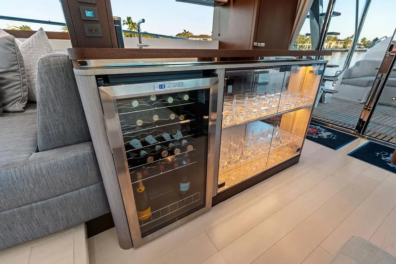 Slide: The Image of Luxurious interior of 2021 Sunseeker Manhattan 68 yacht with wine cooler and glass cabinet. - 44