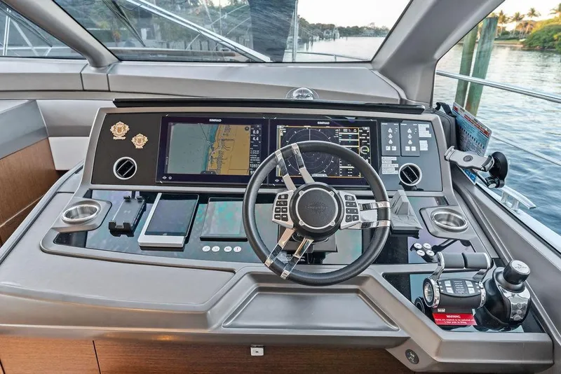 Slide: The Image of Helm of 2021 Sunseeker Manhattan 68 yacht with advanced navigation controls and displays. - 49