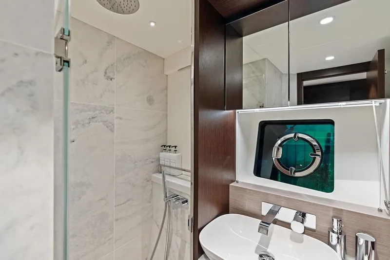 Slide: The Image of Luxurious bathroom in 2021 Sunseeker Manhattan 68 yacht with modern fixtures and porthole window. - 54