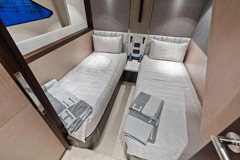 Slide: The Image of Twin cabin interior of 2021 Sunseeker Manhattan 68 yacht, featuring modern design and cozy bedding. - 57