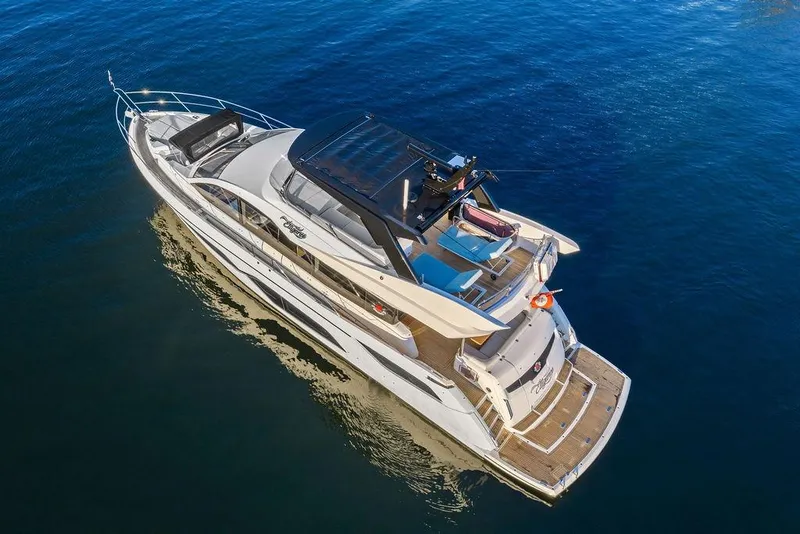 Slide: The Image of 2021 Sunseeker Manhattan 68 yacht cruising on calm blue waters. - 7