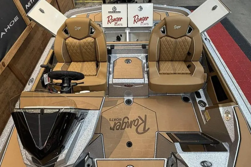 Slide: The Image of 2026 Ranger Z520R Ultra boat interior with tan leather seats and steering wheel. - 13