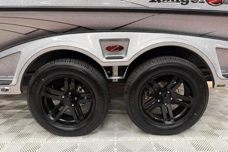 Slide: The Image of 2026 Ranger Z520R Ultra trailer with sleek black wheels on patterned flooring. - 15