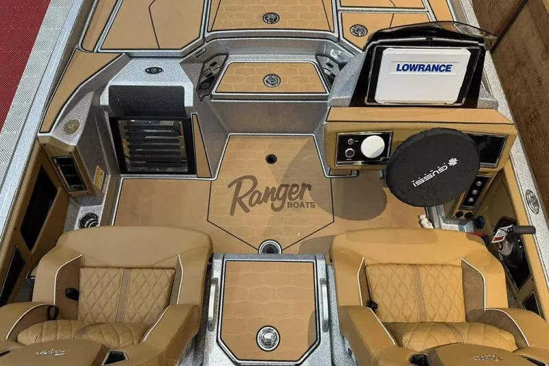 Slide: The Image of Interior of 2026 Ranger Z520R Ultra boat with tan seats and advanced controls. - 7