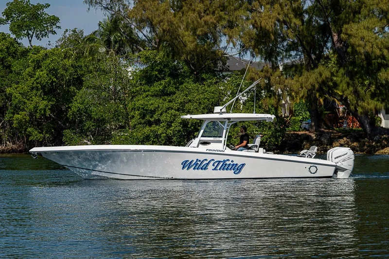 The Image of 2020 Fountain 38 Center Console boat cruising on a calm waterway. - 1