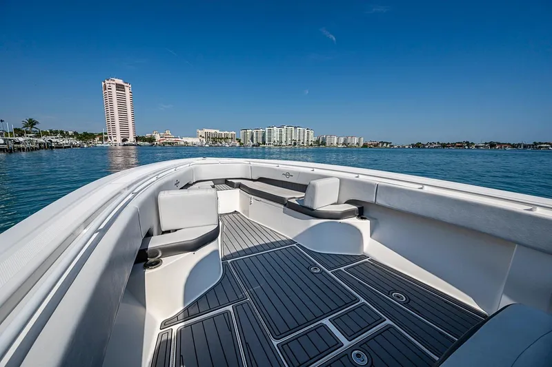 Slide: The Image of 2020 Fountain 38 Center Console boat on calm water with city skyline in background. - 14