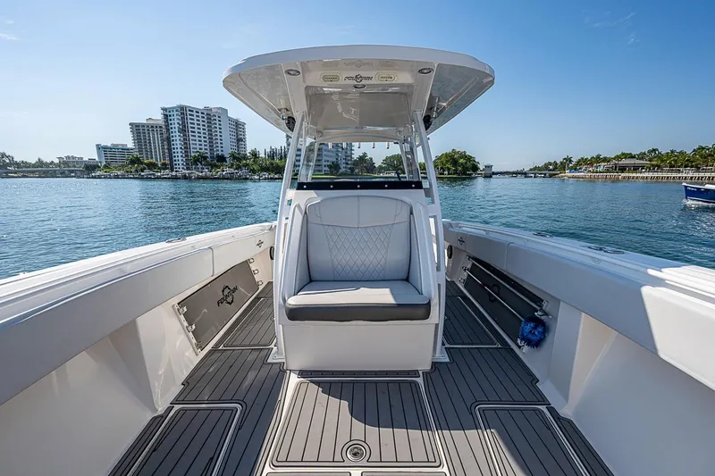Slide: The Image of 2020 Fountain 38 Center Console boat on calm water, city skyline in background. - 16