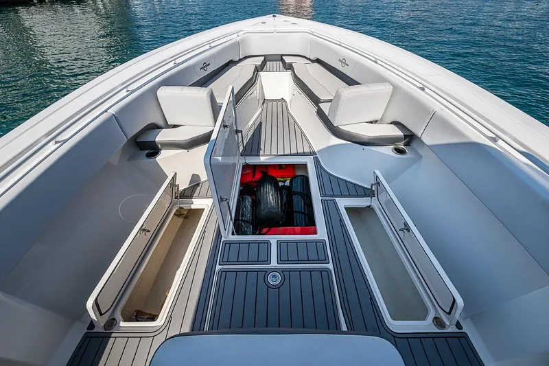 Slide: The Image of 2020 Fountain 38 Center Console boat interior with open storage compartments on calm water. - 19
