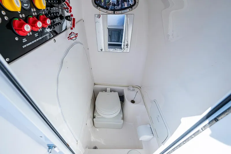 Slide: The Image of 2020 Fountain 38 Center Console boat interior with toilet and control panel. - 20