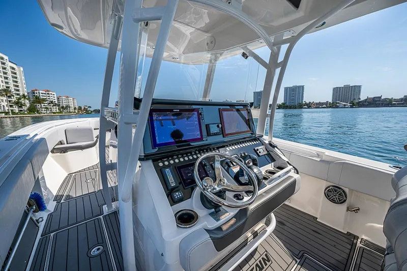 Slide: The Image of 2020 Fountain 38 Center Console boat interior with advanced navigation system on a sunny day. - 21