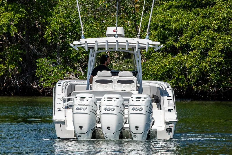 Slide: The Image of 2020 Fountain 38 Center Console boat with triple 400 horsepower engines on water. - 3