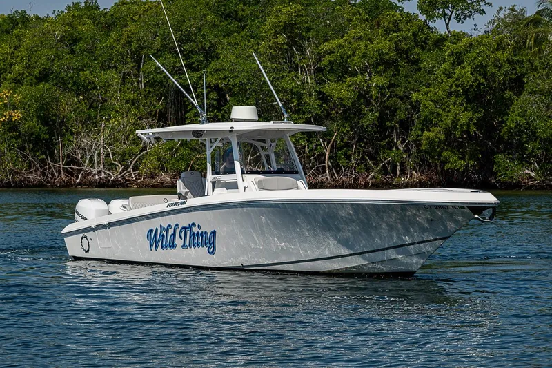 Slide: The Image of 2020 Fountain 38 Center Console boat named "Wild Thing" cruising on water. - 4